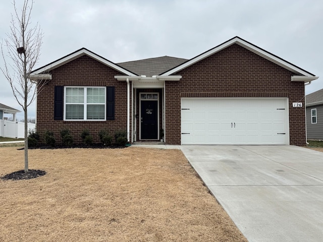 view of front of home with a garage and a front lawn