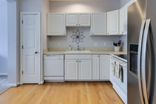 kitchen featuring sink, white appliances, light hardwood / wood-style flooring, and white cabinets