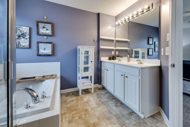 bathroom featuring vanity and tiled tub