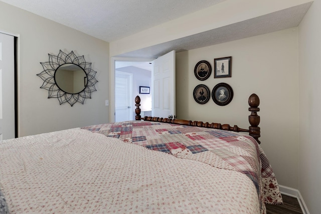 bedroom with hardwood / wood-style flooring and a textured ceiling