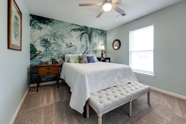 bedroom featuring ceiling fan, carpet, and a textured ceiling