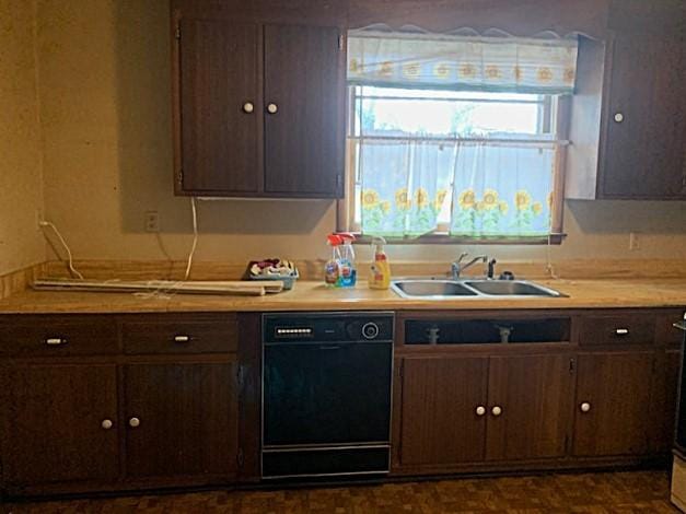 kitchen featuring dark brown cabinetry, sink, and black dishwasher