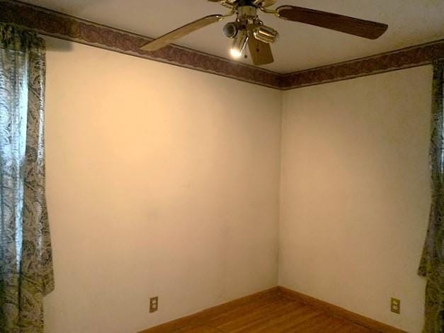 unfurnished room featuring hardwood / wood-style flooring and ceiling fan