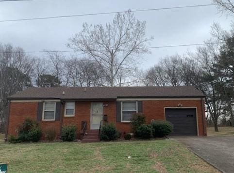 ranch-style house with a garage and a front lawn