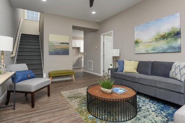 living room featuring hardwood / wood-style floors and ceiling fan