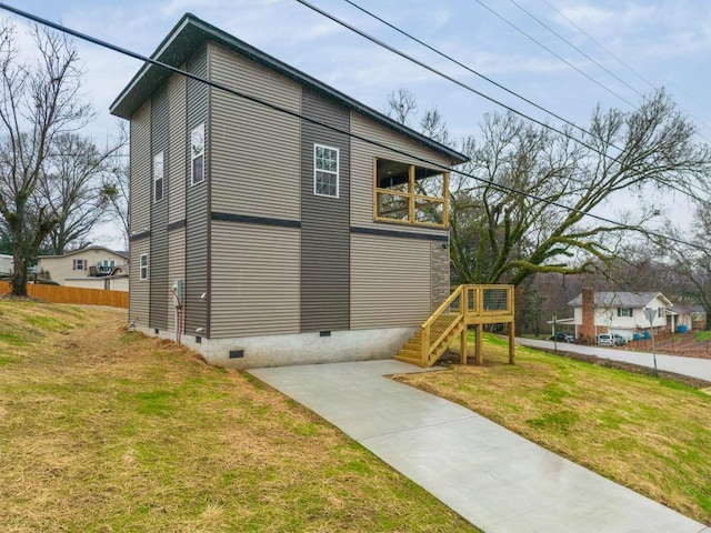 view of side of property with a lawn