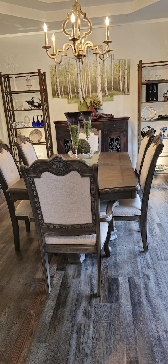 dining space with an inviting chandelier and hardwood / wood-style flooring