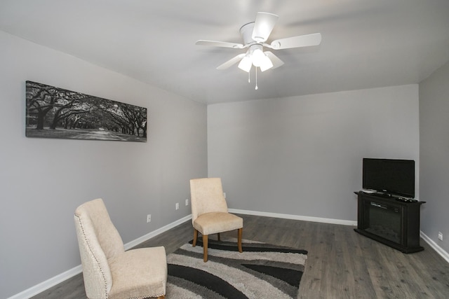 living area featuring ceiling fan, wood finished floors, and baseboards