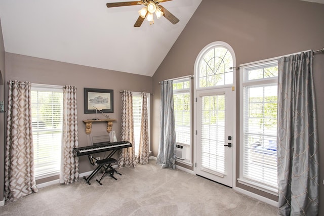 interior space with ceiling fan, baseboards, high vaulted ceiling, and carpet floors