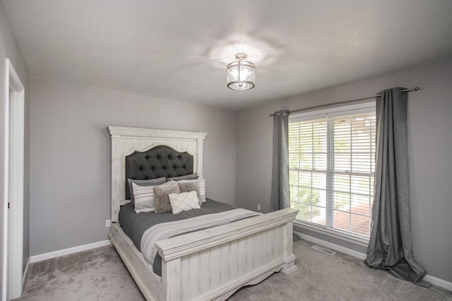 bedroom featuring visible vents, carpet, and baseboards