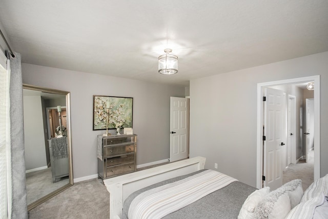 bedroom with baseboards and light colored carpet