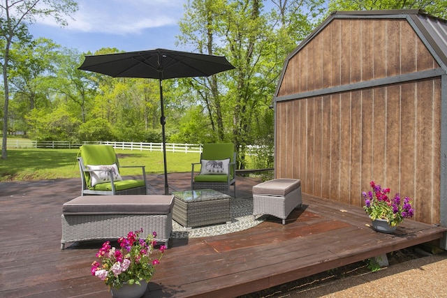 wooden terrace featuring fence and an outdoor living space