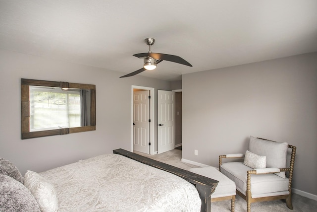 carpeted bedroom with a ceiling fan and baseboards