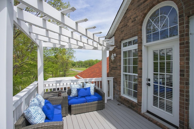 wooden deck featuring a pergola and an outdoor hangout area
