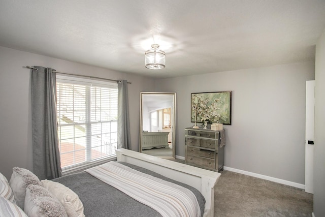 carpeted bedroom featuring baseboards