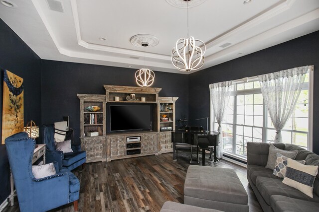 living area with visible vents, a raised ceiling, a chandelier, recessed lighting, and wood finished floors