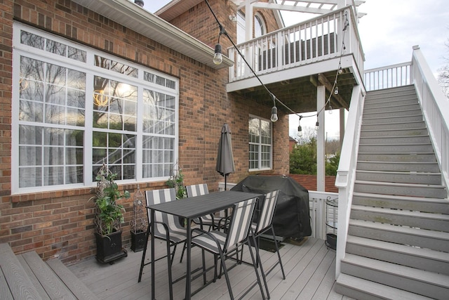 deck with outdoor dining area and area for grilling