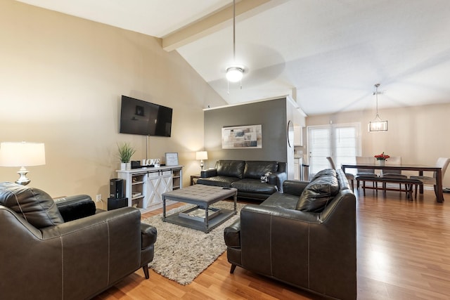 living room featuring vaulted ceiling with beams, hardwood / wood-style floors, and ceiling fan