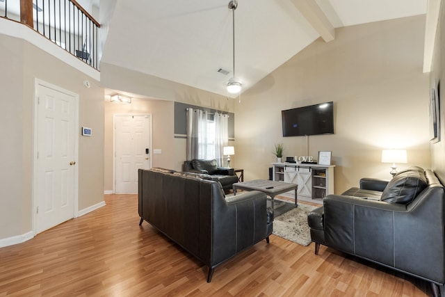 living room with beamed ceiling, high vaulted ceiling, and light wood-type flooring