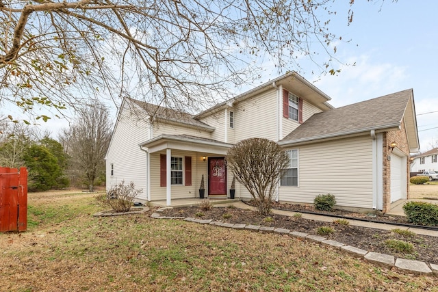 front facade featuring a garage, a front yard, and a porch