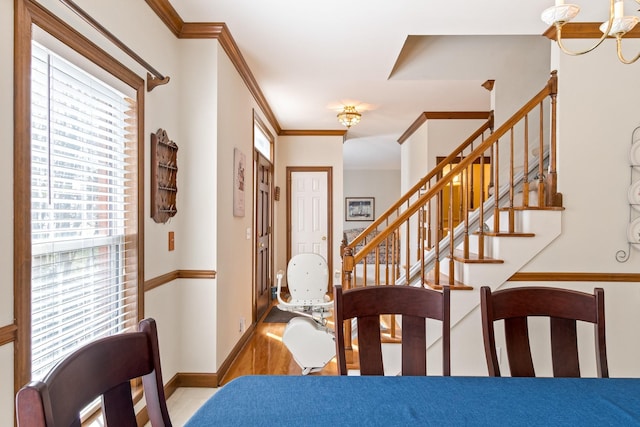 dining space with crown molding and light hardwood / wood-style floors