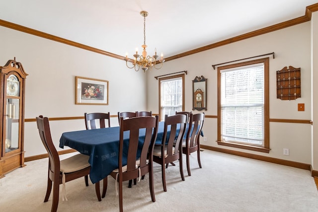 dining area featuring a notable chandelier, light colored carpet, and ornamental molding