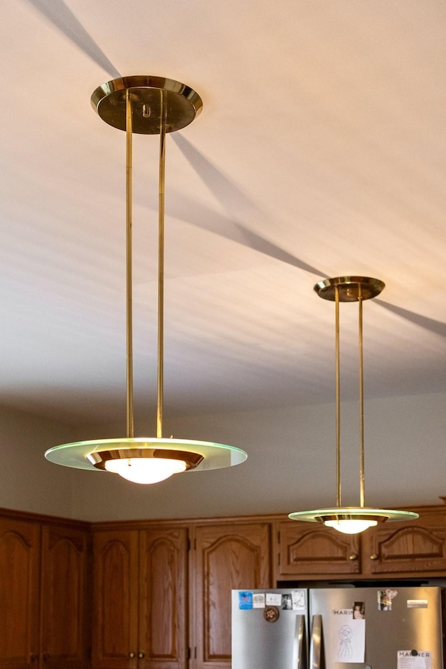 interior details with stainless steel refrigerator and pendant lighting