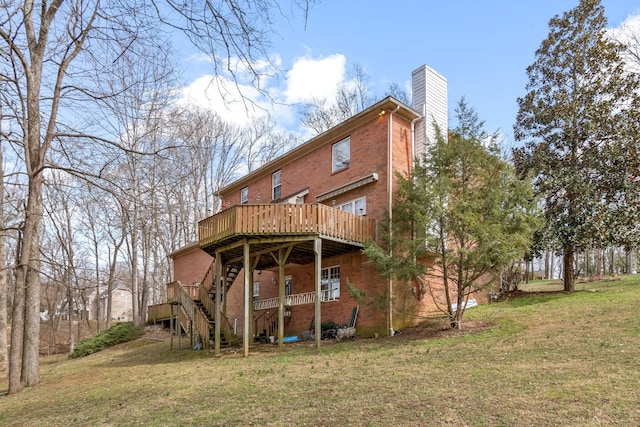 rear view of house with a yard and a deck