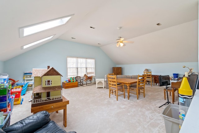 rec room featuring vaulted ceiling with skylight, ceiling fan, and carpet flooring