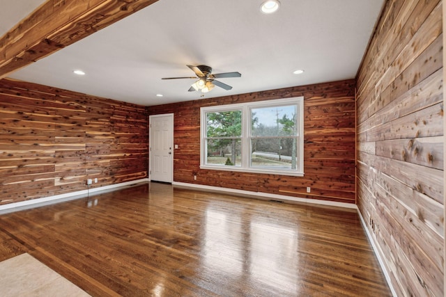 empty room with dark hardwood / wood-style floors and ceiling fan