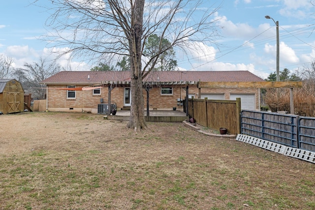 back of property featuring central AC, a shed, and a lawn