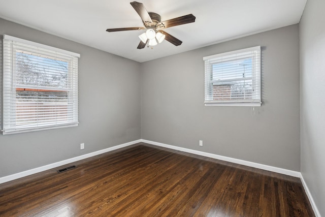 unfurnished room with dark wood-type flooring and ceiling fan