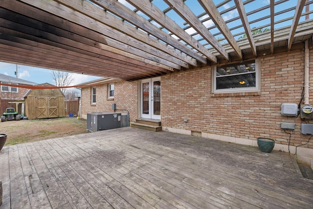 deck with a pergola and a shed