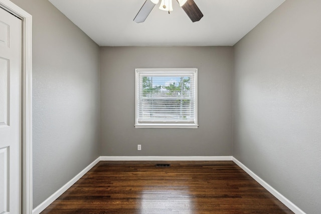 empty room with dark wood-type flooring and ceiling fan