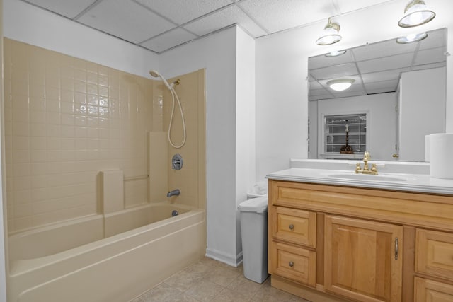 bathroom with vanity, a paneled ceiling, tile patterned floors, and tiled shower / bath