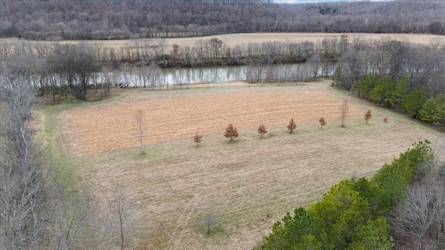 birds eye view of property featuring a water view and a rural view