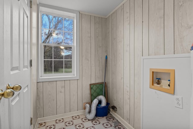 washroom with hookup for a washing machine, a wealth of natural light, and wooden walls