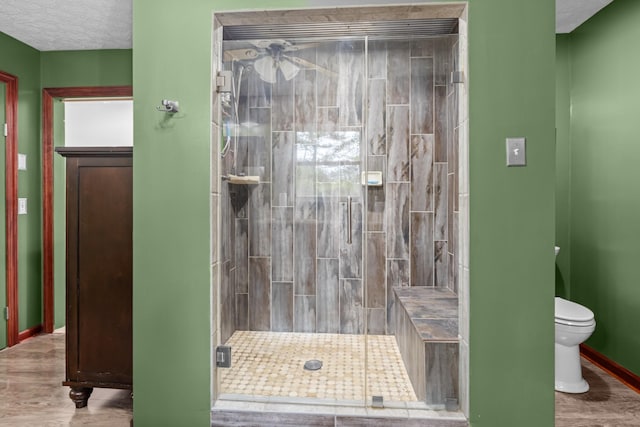 bathroom with walk in shower, toilet, a textured ceiling, and hardwood / wood-style flooring