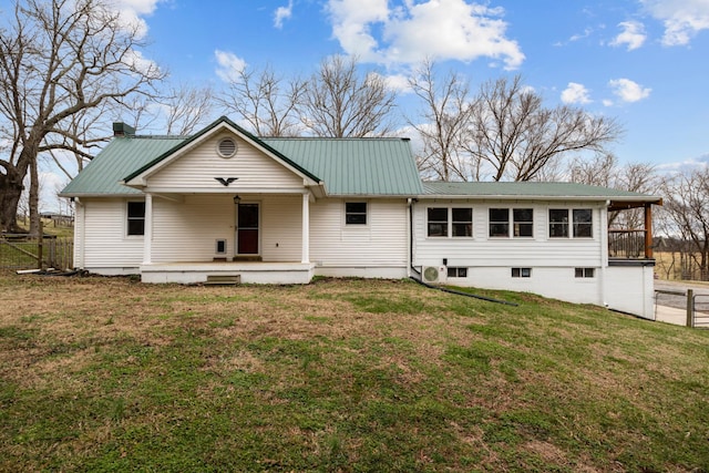 rear view of property with a yard