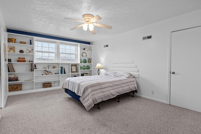 carpeted bedroom with ceiling fan and a textured ceiling