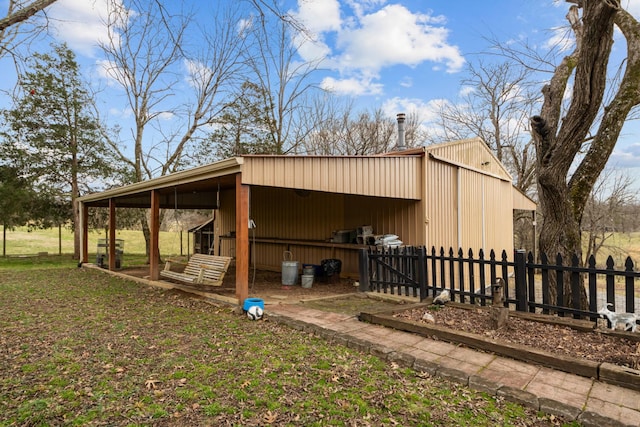 view of outdoor structure featuring a lawn