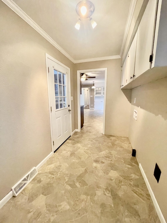 laundry area featuring ornamental molding, cabinets, and ceiling fan