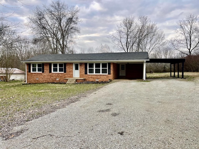 ranch-style house with a carport and a front lawn