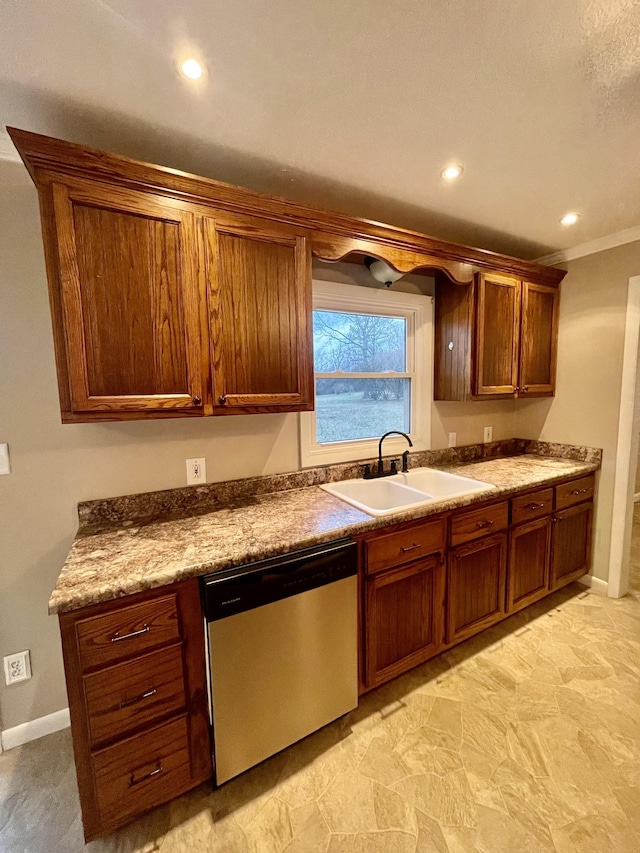 kitchen featuring ornamental molding, dishwasher, sink, and stone counters