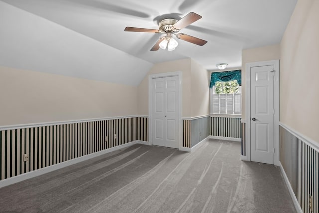 bonus room featuring lofted ceiling and light carpet