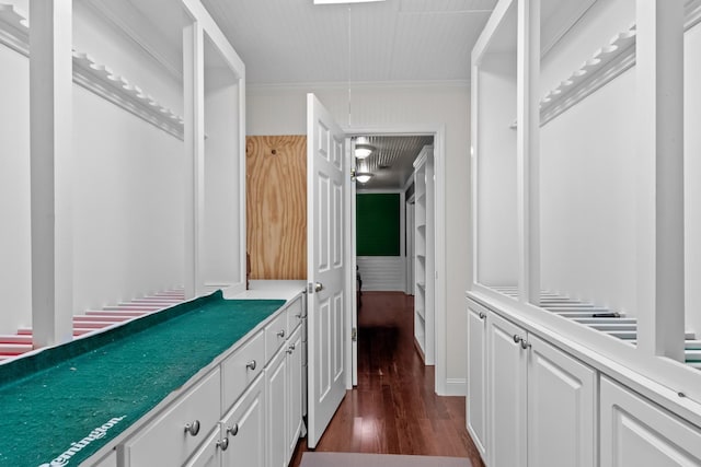 interior space featuring wood-type flooring and crown molding