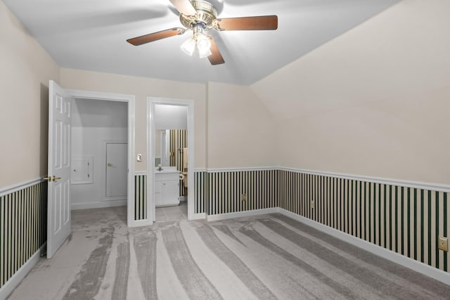 additional living space featuring light colored carpet and vaulted ceiling
