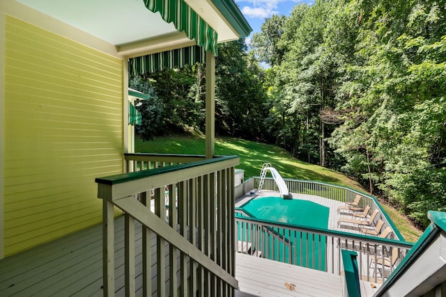 wooden terrace featuring a lawn