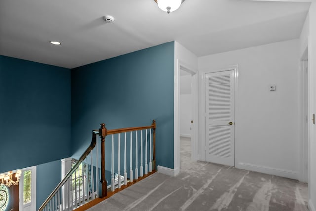 hall featuring carpet flooring