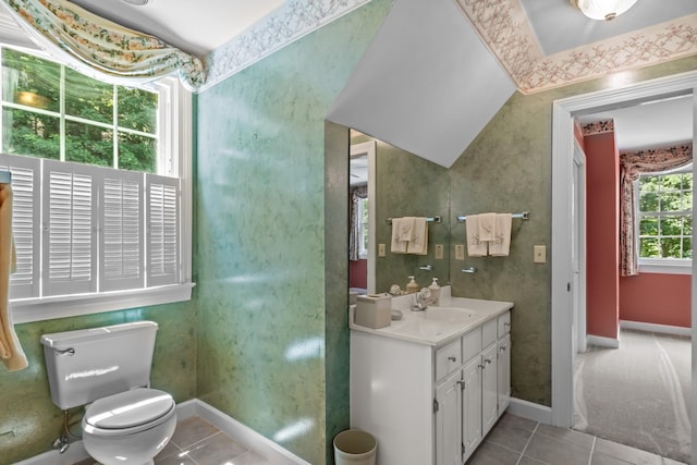 bathroom featuring tile patterned flooring, vanity, vaulted ceiling, and toilet